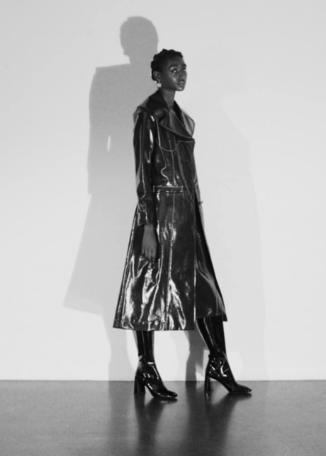 Faux shiny leather long coat paired with luminous skin