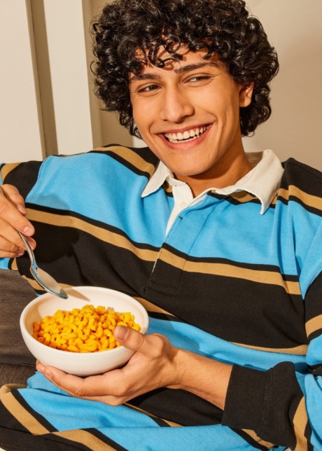 Ad shot for Kraft Dinner man eating mac and cheese