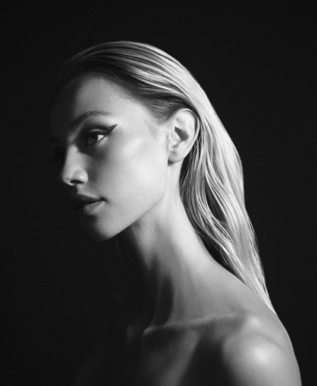 Black and white portrait with a strong contrast between light and dark