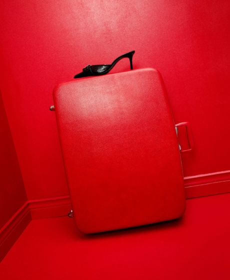 Red set design fashion editorial red suitcase and a black heel