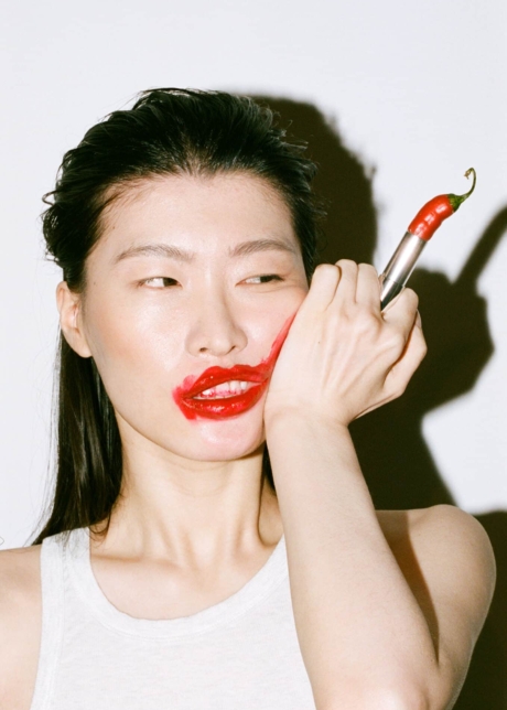 Eat Cops Fall Winter 2022 model with a red hot chilli pepper lipstick