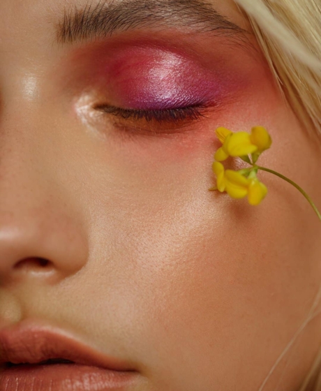 Close up detail shot of an eye with peach pink and purple shadows