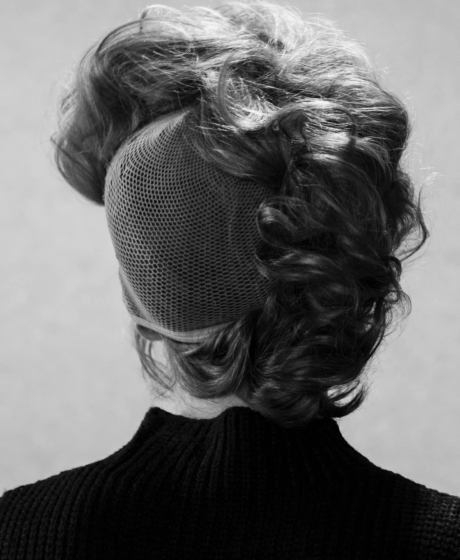 Black and white portrait of a woman's back showcasing her hair style