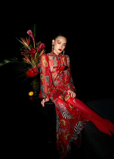 Woman wearing a red dress with a floral arragement in the back editorial for three magazine