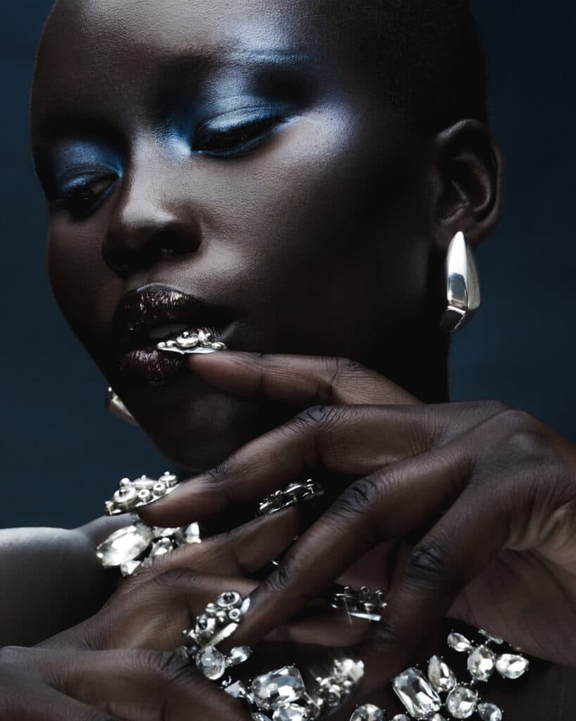 Creative beauty on dark skin model blue shadows and glossy lip by Robert Weir